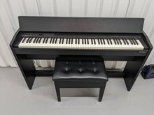 Load image into Gallery viewer, Roland F140R Digital Piano in black with matching colour stool stock # 24063