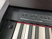 Load image into Gallery viewer, Roland F140R Digital Piano in black with matching colour stool stock # 24063