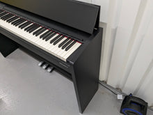 Load image into Gallery viewer, Roland F140R Digital Piano in black with matching colour stool stock # 24063