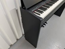 Load image into Gallery viewer, Roland F140R Digital Piano in black with matching colour stool stock # 24063