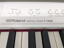 Load image into Gallery viewer, Roland F140R Digital Piano in satin white slim line space saver stock # 24246