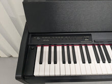 Load image into Gallery viewer, Roland F110 compact slim size Digital Piano in black stock # 24580