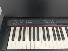 Load image into Gallery viewer, Roland F140R Digital Piano in satin black slim line space saver stock # 25303