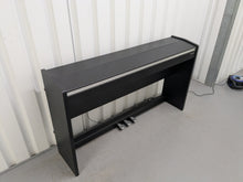 Load image into Gallery viewer, Roland F140R Digital Piano in satin black slim line space saver stock # 25351