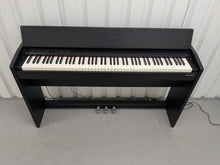 Load image into Gallery viewer, Roland F140R Digital Piano in satin black slim line space saver stock # 25351