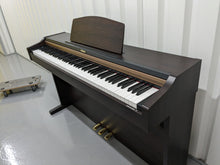 Load image into Gallery viewer, Roland HP101e Digital Piano in rosewood weighted keys 3 pedals, stock # 23082