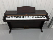 Load image into Gallery viewer, Roland HP101e Digital Piano in rosewood weighted keys 3 pedals, stock # 23082