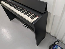 Load image into Gallery viewer, Roland F130R Digital Piano in black with matching colour stool stock # 23495
