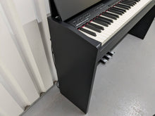 Load image into Gallery viewer, Roland F140R Digital Piano in black with matching colour stool stock # 24063
