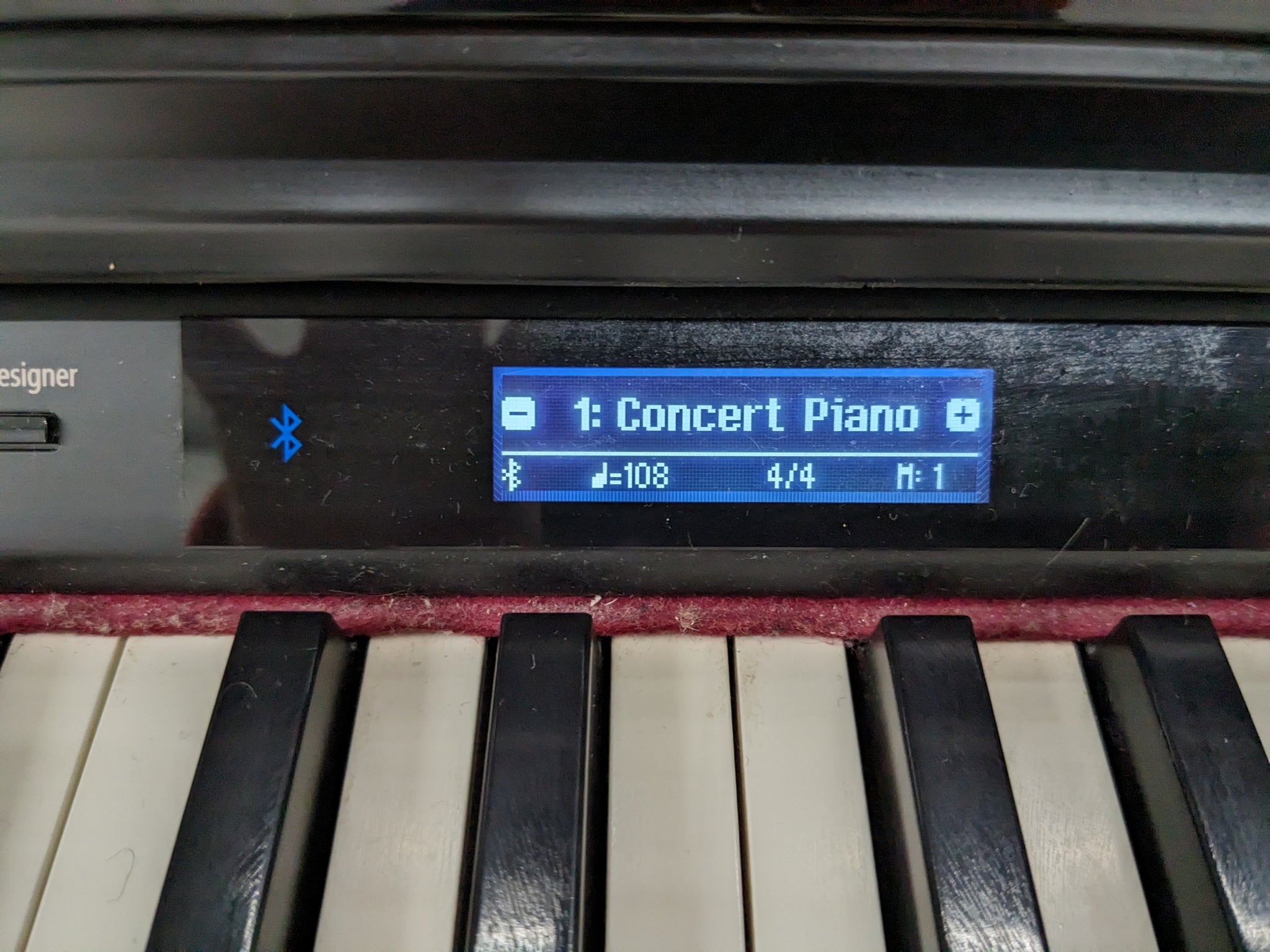Roland HP605 digital piano and stool in glossy black polished