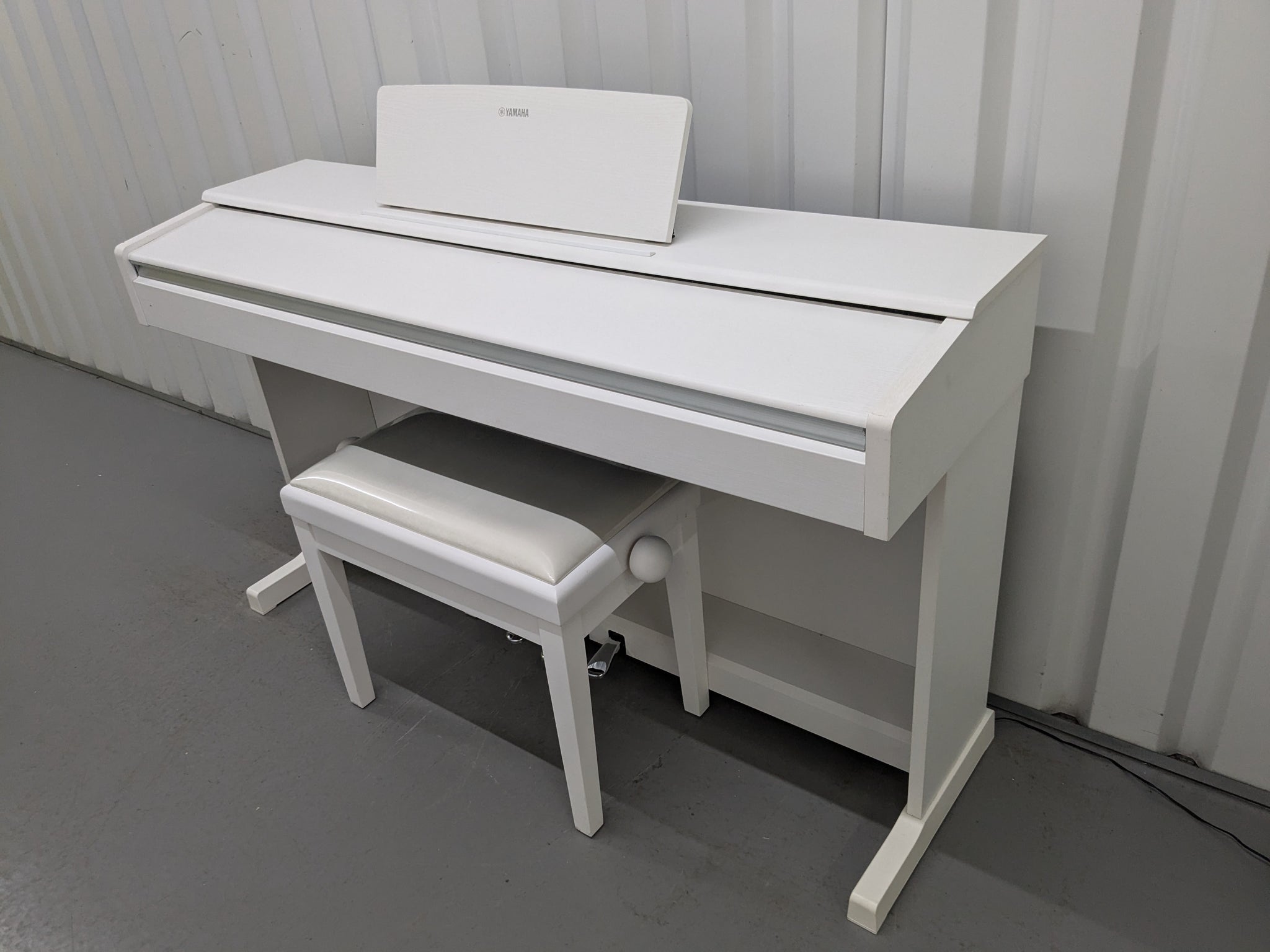 Yamaha Arius YDP-144 digital piano and stool in satin white stock