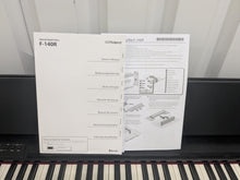 Load image into Gallery viewer, Roland F140R Digital Piano in satin black slim line space saver stock # 25303
