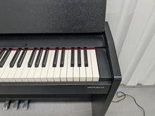 Load image into Gallery viewer, Roland F140R Digital Piano in satin black slim line space saver stock # 25351
