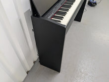 Load image into Gallery viewer, Roland F140R Digital Piano in satin black slim line space saver stock # 25351
