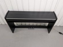 Load image into Gallery viewer, Roland F140R Digital Piano in satin black slim line space saver stock # 26060
