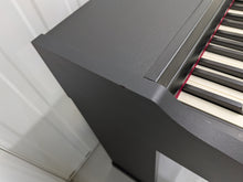 Load image into Gallery viewer, Roland RP102 digital piano and stool in satin black finish stock number 26290
