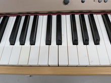 Load image into Gallery viewer, Roland HP102e digital piano in light oak finish stock number 26381
