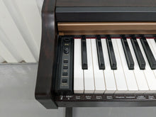 Load image into Gallery viewer, Roland HP101e Digital Piano in rosewood weighted keys 3 pedals, stock # 23082
